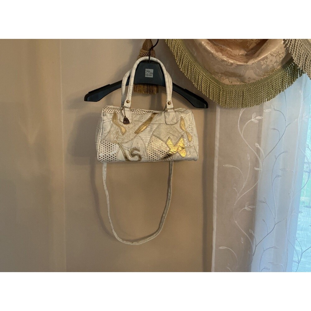 Cross body white leather handbag with unique patchwork and shoulder strap.